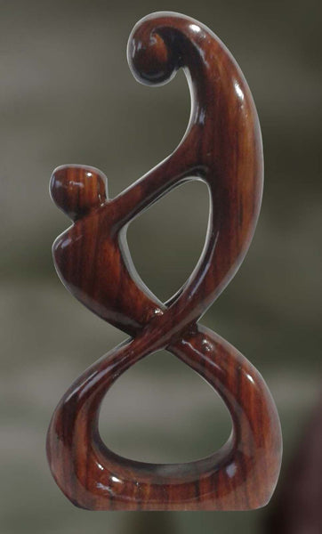 Wood sculpture of couple in intimate union