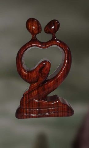 Wood sculpture of a couple in conjugal union