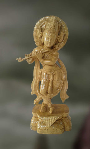 Wood sculpture of Lord Krishana playing flute