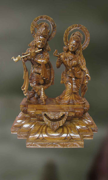 Wood sculpture of Krishna playing his divine flute