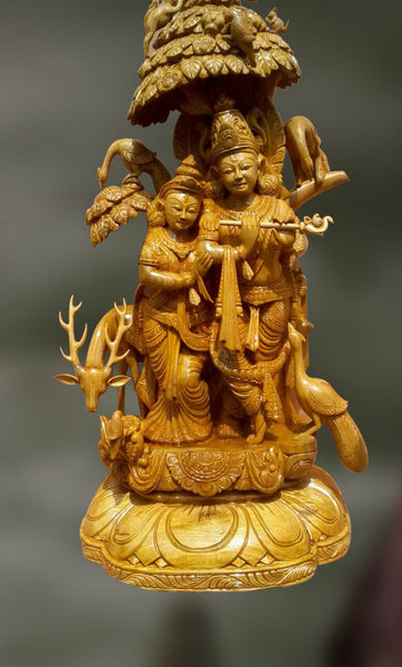 Wood sculpture of radha and krishna together 