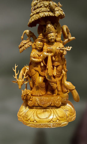 Wood sculpture of radha and krishna together 