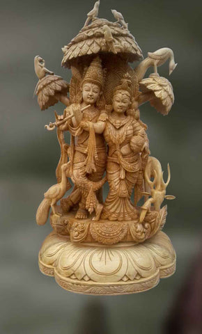 Wood sculpture of radha and krishna together 