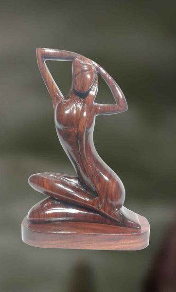 Wood sculpture of woman in a relaxed posture 